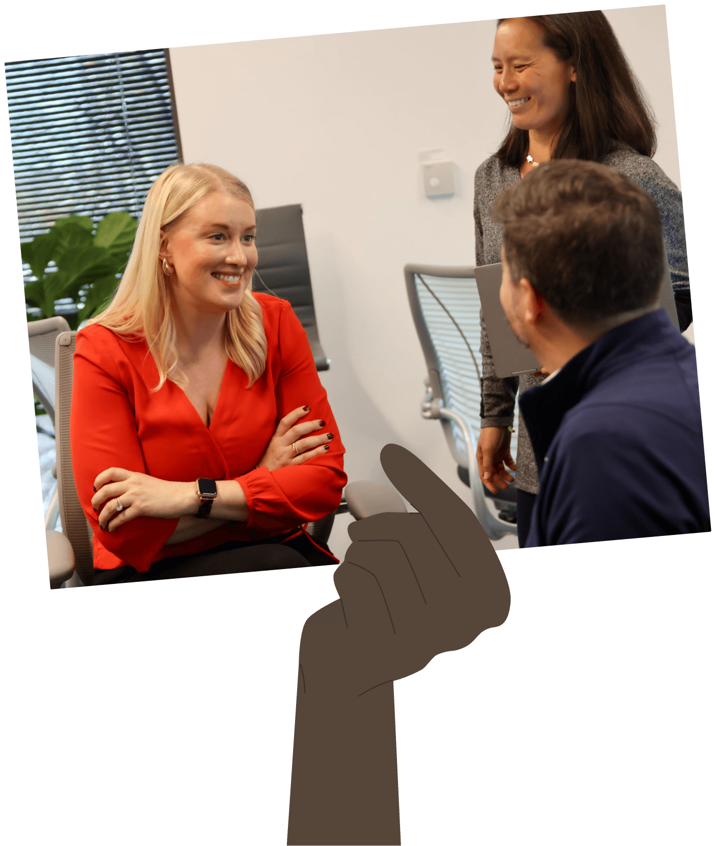 Hand Holding Up Image of Three People Meeting