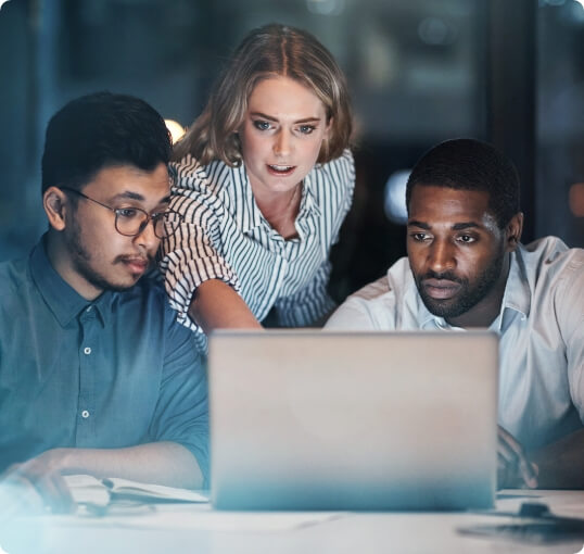 Three People Looking at Laptop