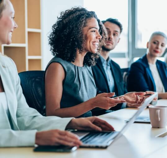Woman Smiling Leading a Meeting