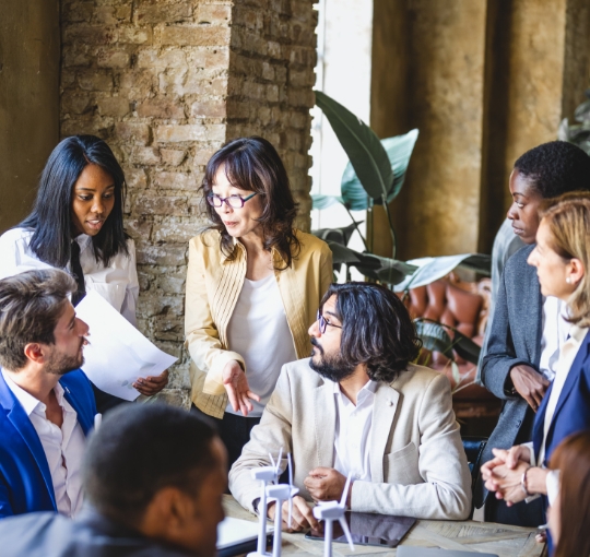 Group of Coworkers Discussing Something in Meeting Room